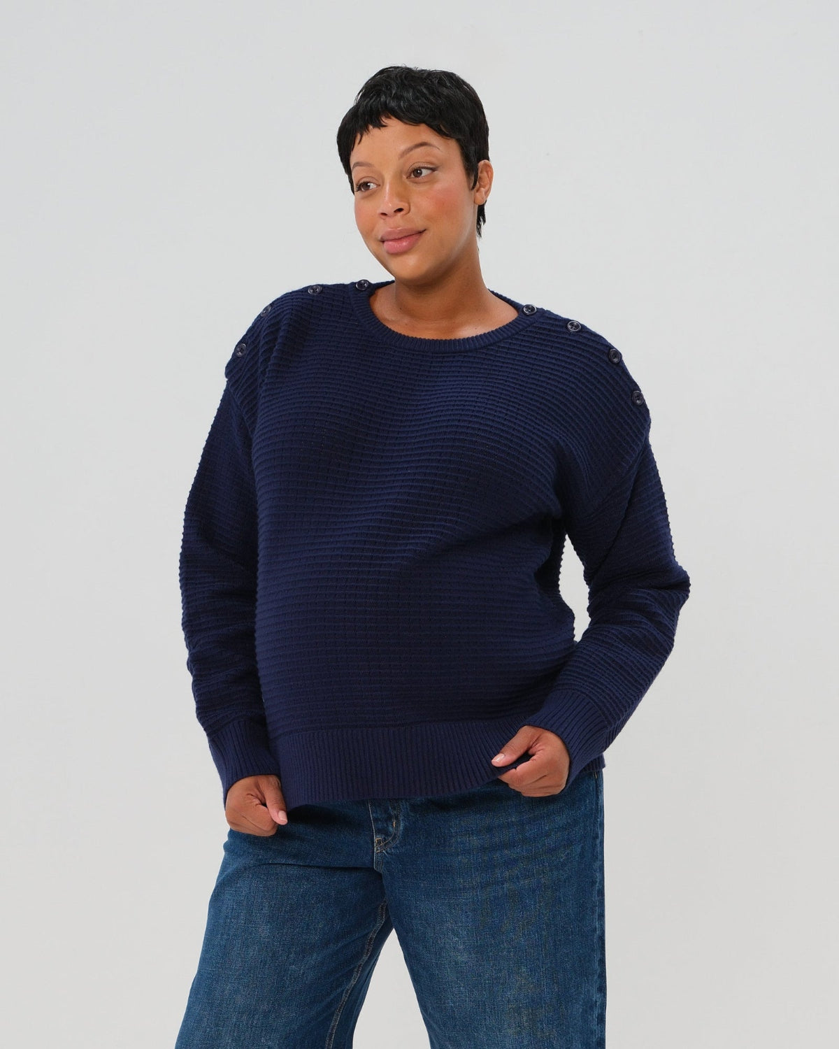 Navy premium maternity and nursing sweater in stretch cotton box knit. Featuring shoulder button detail for breastfeeding and discreet hem thumbholes for an extra cozy fit. Oversized fit is flattering, polished, and versatile - transitioning from pregnancy workwear to loungewear to streetwear with ease. Petite and tall friendly; available in regular and plus size. 