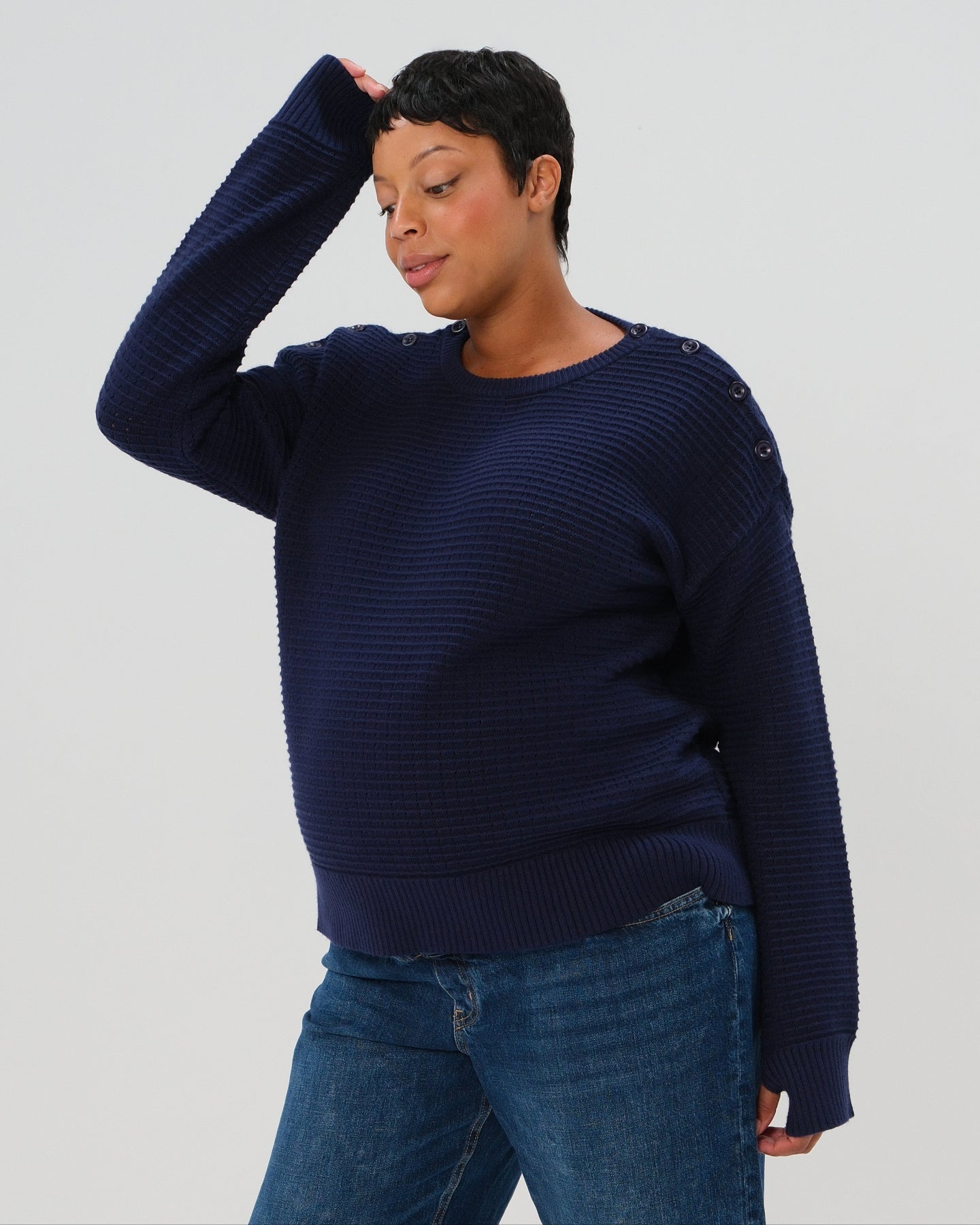 Navy premium maternity and nursing sweater in stretch cotton box knit. Featuring shoulder button detail for breastfeeding and discreet hem thumbholes for an extra cozy fit, our 5-star reviews for best maternity sweater are no surprise. This sweater's oversized fit is flattering, polished, and versatile - transitioning from pregnancy workwear to loungewear to streetwear with ease. Petite and tall friendly; available in regular and plus sizes in 2026. 