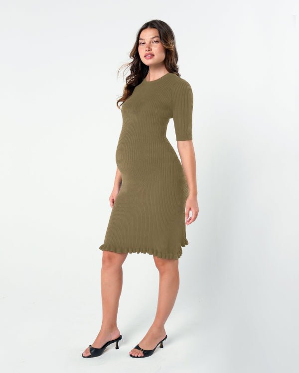 Olive green knit maternity dress in black and white. This premium knee length pregnancy dress features three-quarter length sleeves with a feminine hem detail. Ideal for maternity business workwear, date night, church, a wedding guest outfit, brunch, and occasion wear. Petite and tall friendly. MARION offers the best luxury maternity workwear and fashion on the market.