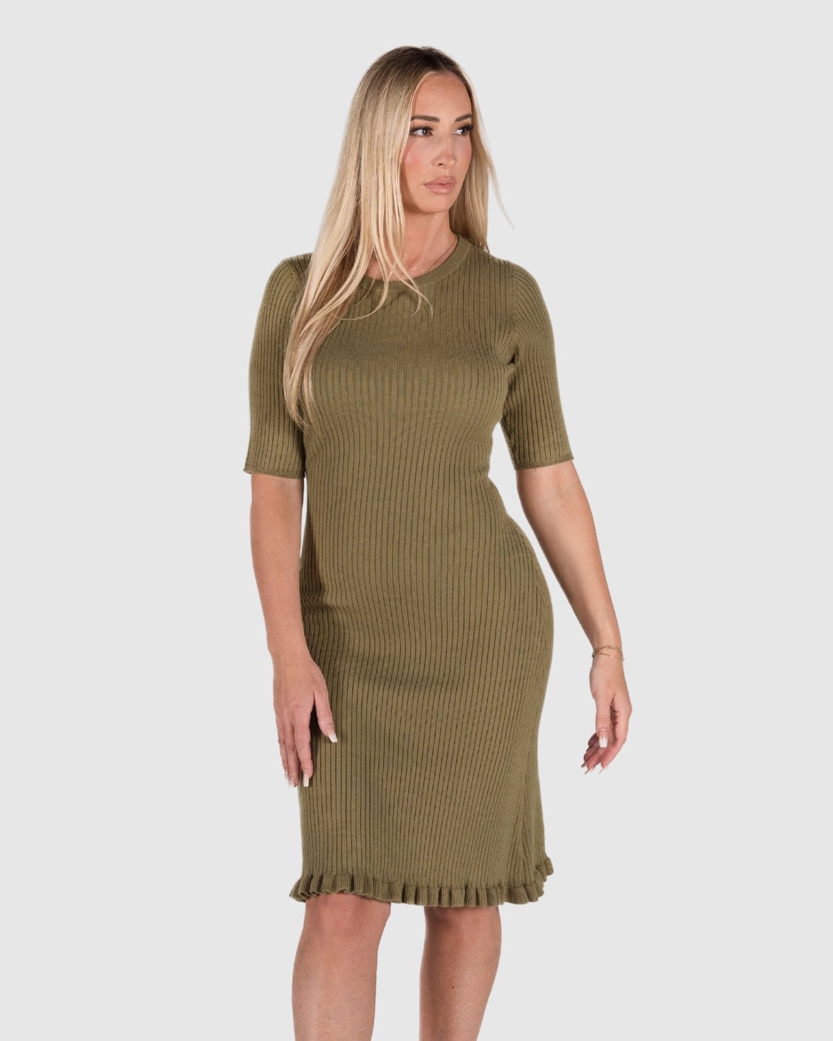 Postpartum model and mama wearing MARION olive green knit luxury maternity and postpartum sweater dress. Knee length with feminine hem detail, 3/4 sleeves, and crew neck. Made with high quality, comfortable cotton stretch knit. Petite and tall friendly, for work, wedding guest, baby shower, street style, party, or date night. Not a nursing style. 
