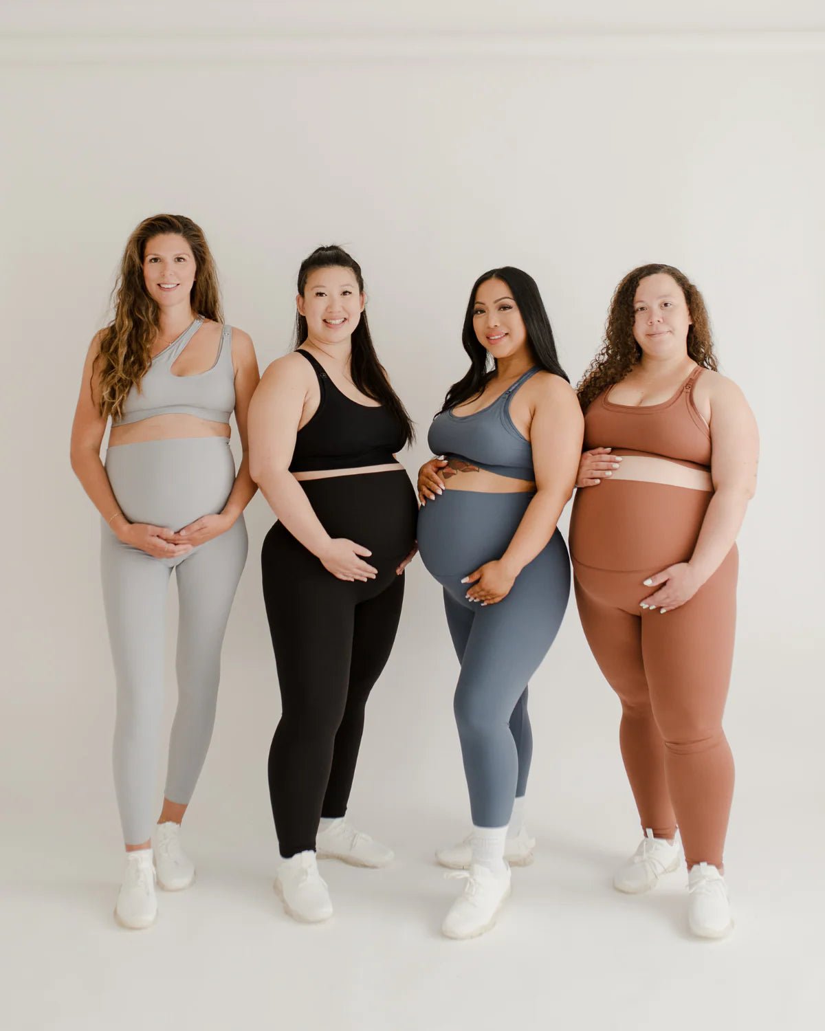 Pregnant models wearing premium AXK maternity leggings with a supportive high waist, bum flattering back v seam, seamless front design, and butter soft stretch fabric. Best selling with glowing 5-star reviews, these leggings are perfect for running, pregnancy yoga, walking, biking, or loungewear. High quality 2026 maternity athletic and activewear in regular and plus sizes. Petite and tall friendly. 