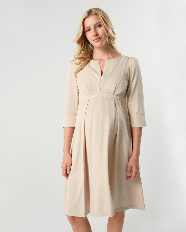 Beige maternity and nursing empire dress for business, baby shower, wedding guest, party, and formal occasions. Sustainable TENCEL, zipper breastfeeding access, and full skirt with deep pockets. Petite and standard sizes.