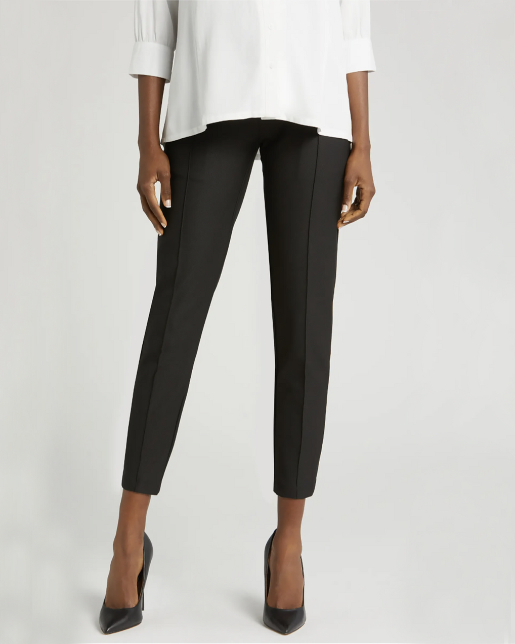 Black maternity work pants with stretch belly for bump comfort. Luxury maternity workwear trousers cut with stretch Italian suiting fabric. Featuring real pockets and slimming princess seams. Washable, sustainable, petite friendly business attire separates, perfect for pairing with a blazer as a pregnancy pantsuit. Courtroom friendly clothes for pregnant lawyers. 