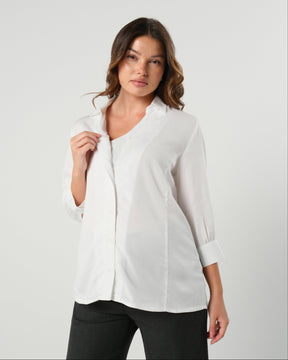 White maternity button down shirt for pregnancy and nursing by MARION. Maternity workwear top with no gap technology that prevents your bra from showing. Cut with luxury sustainable TENCEL, this classic blouse is ideal for a business meeting at the office, the courtroom, or Saturday errands and brunch. Available in petite and regular sizes, and made for pregnancy, nursing, postpartum, and mama life. 