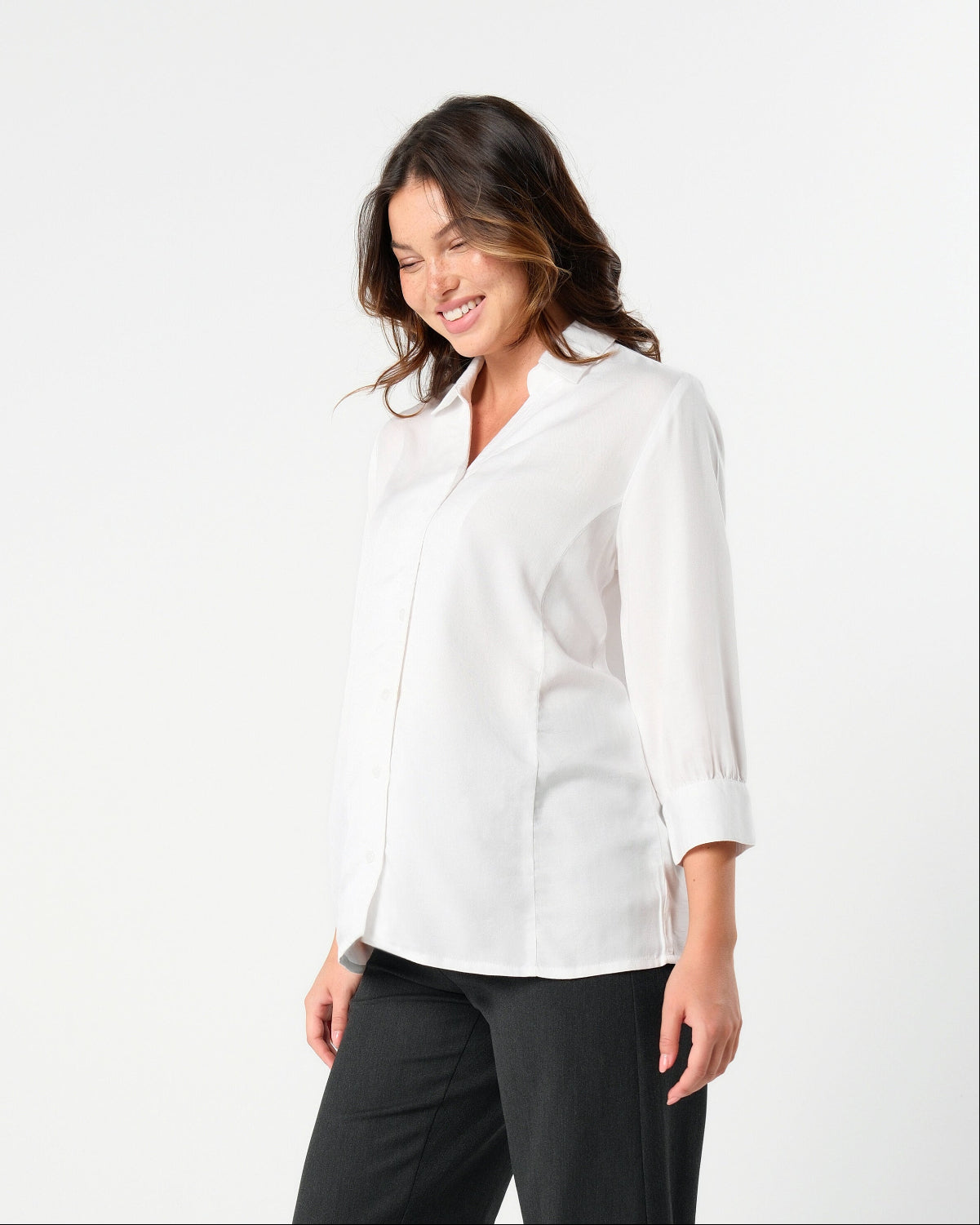 White maternity button down shirt for pregnancy and nursing by MARION. Maternity workwear top with no gap technology that prevents your bra from showing. Cut with luxury sustainable TENCEL, this classic blouse is ideal for a business meeting at the office, the courtroom, or Saturday errands and brunch. Available in petite and regular sizes, and made for pregnancy, nursing, postpartum, and mama life. 