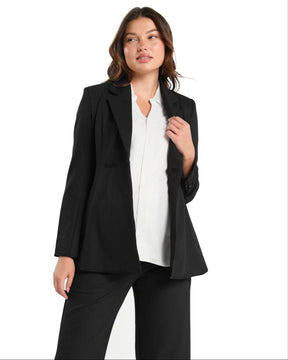 White maternity button down shirt for pregnancy and nursing by MARION. Maternity workwear top with no gap technology that prevents your bra from showing. Cut with luxury sustainable TENCEL, this classic blouse is ideal for a business meeting at the office, the courtroom, or Saturday errands and brunch. Available in petite and regular sizes, and made for pregnancy, nursing, postpartum, and mama life. 