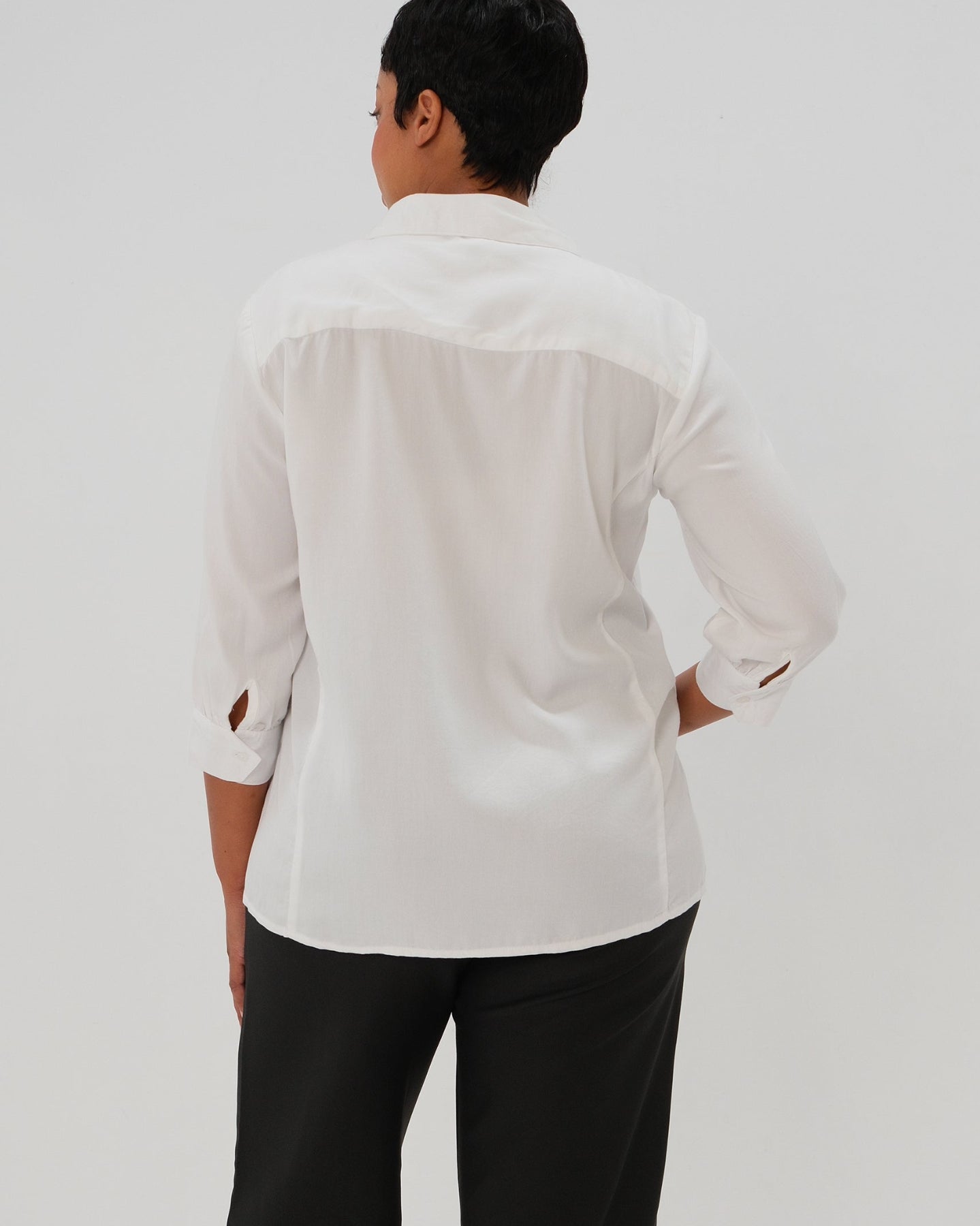 Plus size woman in maternity button down shirt for pregnancy and nursing by MARION with dozens of 5-star reviews. Maternity workwear top with no gap technology that prevents your bra from showing. Cut with luxury sustainable TENCEL, this classic blouse is the best possible choice for your business meeting at the office, the courtroom, or Saturday errands. For 2026, now available in petite sizes; made for pregnancy, nursing, postpartum, and womenswear. Sold by Nordstrom, Bloomingdale's, and Macy's.