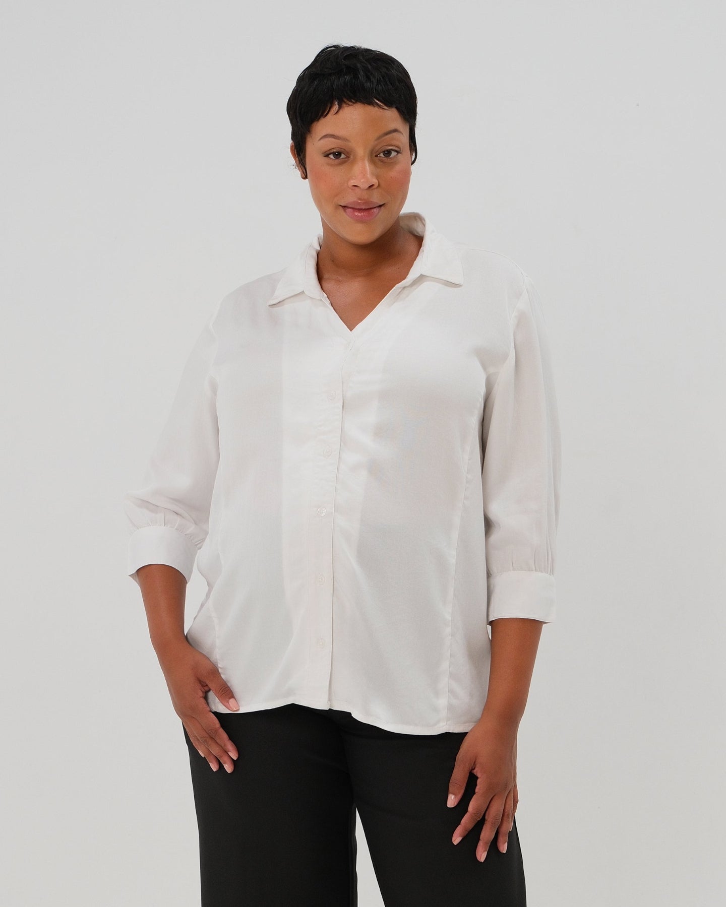 Plus size woman in maternity button down shirt for pregnancy and nursing by MARION with dozens of 5-star reviews. Maternity workwear top with no gap technology that prevents your bra from showing. Cut with luxury sustainable TENCEL, this classic blouse is the best possible choice for your business meeting at the office, the courtroom, or Saturday errands. For 2026, now available in petite sizes; made for pregnancy, nursing, postpartum, and womenswear. Sold by Nordstrom, Bloomingdale's, and Macy's.