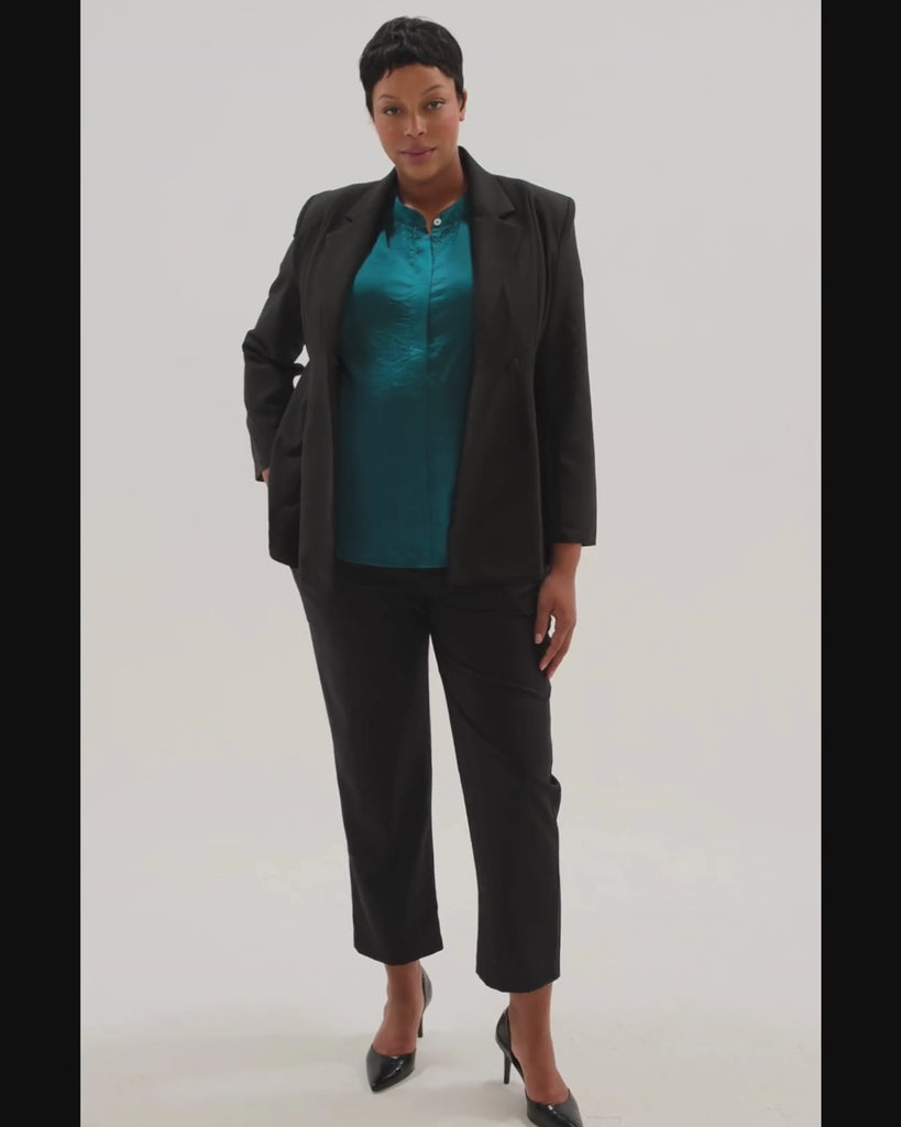Plus size model wearing a black maternity suit blazer for work, paired with black maternity work trousers. Perfect maternity suit separates.