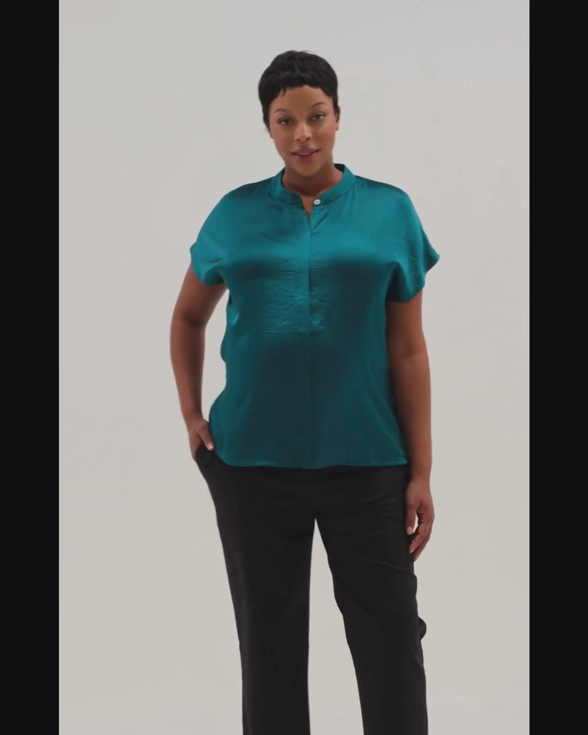 Video of plus size pregnant woman wearing a luxury turquoise green blue maternity and nursing shell top. Pregnancy business attire for work and the courtroom. Pregnant lawyer and petite friendly. High quality jewel teal breastfeeding workwear shirt by MARION. 