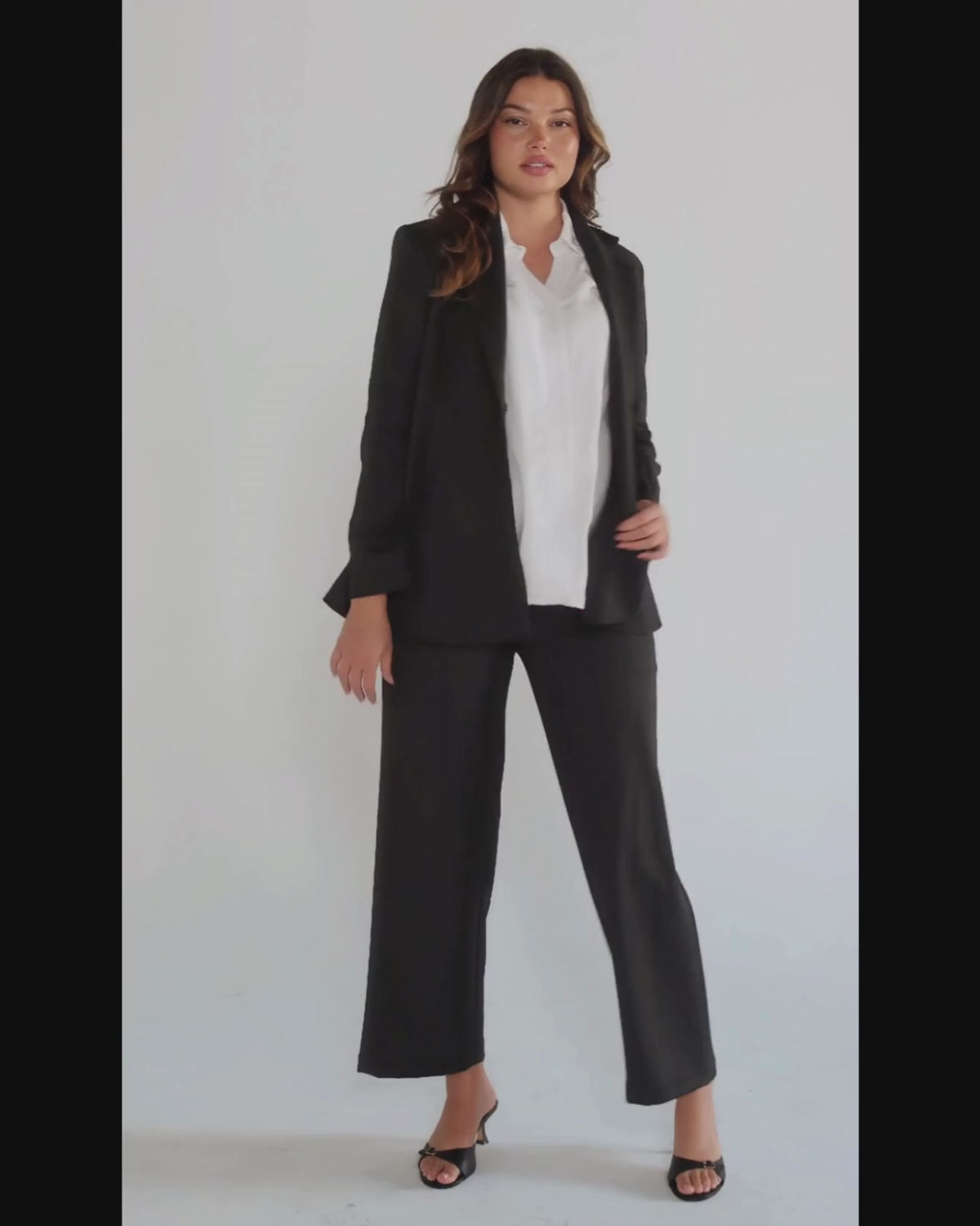 Black maternity wide leg dress pants for work with over belly band. Sustainable pregnancy business trousers cut with luxury Italian suiting fabric. Perfect maternity bottom pant suit separates.