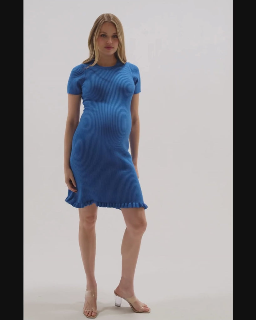 Video of a pregnant woman wearing a premium blue short sleeve maternity sweater dress with 3/4 sleeves, feminine ruffle hem detail, and luxurious cotton stretch knit. This best in class design is perfect for work outfits, wedding guest, holiday parties, baby showers, and street style. Postpartum friendly. 2026 MARION core season collection. 