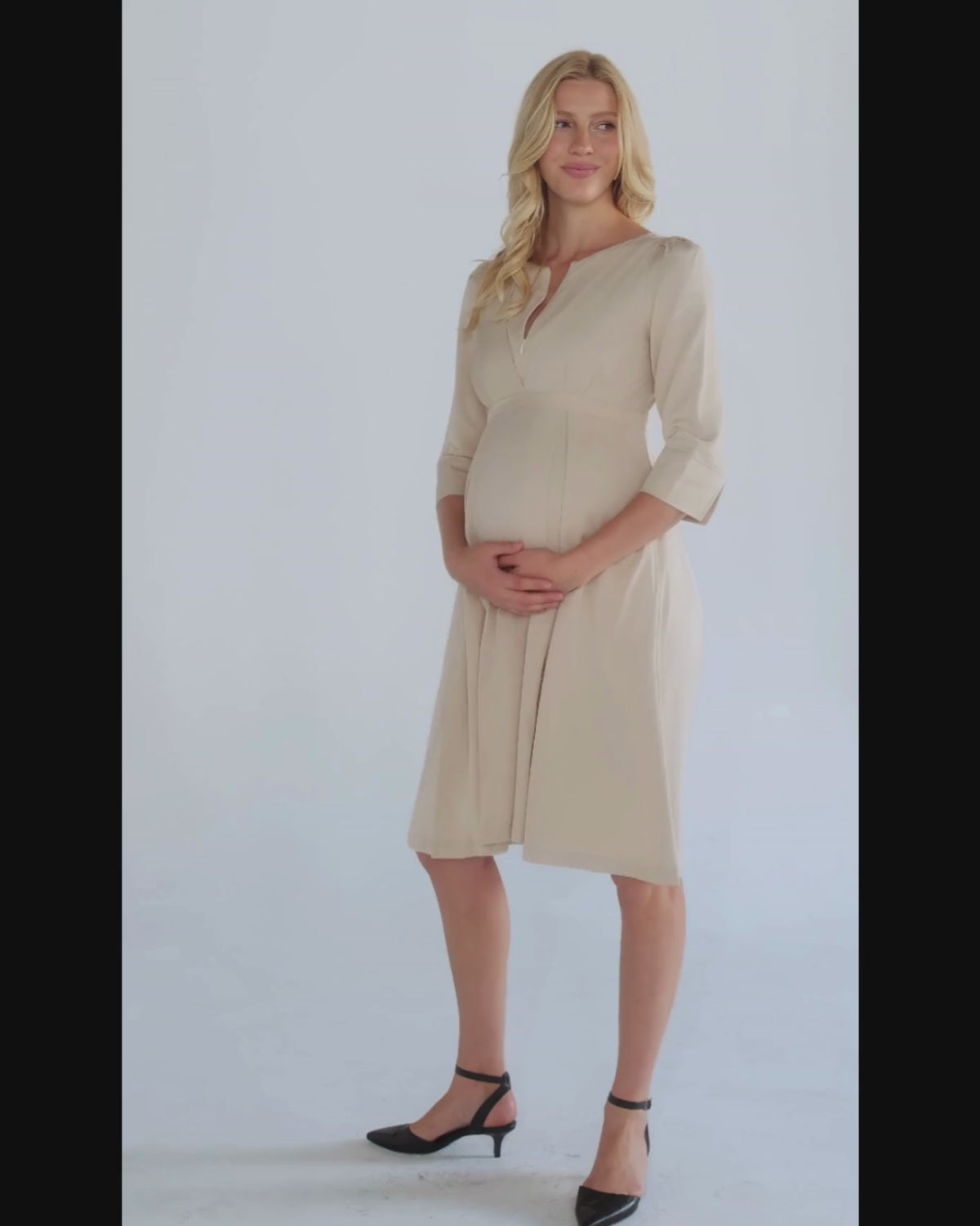 Beige maternity and nursing empire dress for business attire, baby shower, wedding guest, party, and formal occasions. Sustainable TENCEL, zipper breastfeeding access, and full skirt with deep pockets. MARION offers the market's best premium maternity dresses in petite and standard sizes.