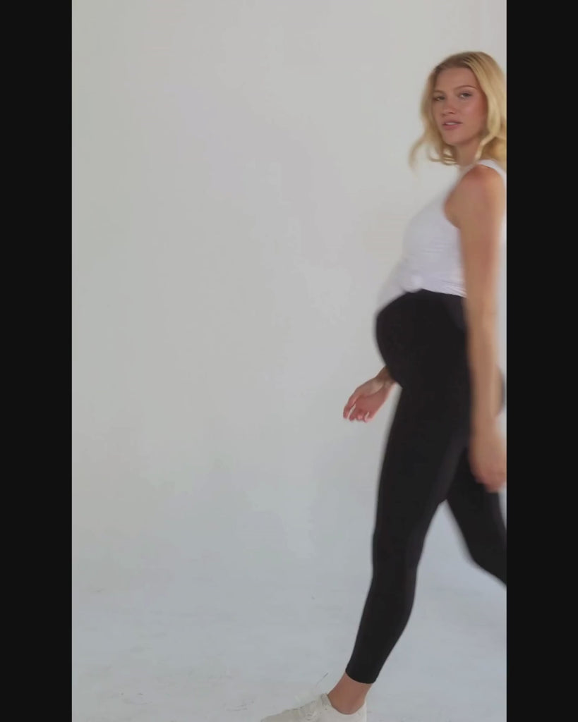 Black MARION maternity leggings with cell phone pocket, made of soft, luxury recycled nylon for pregnancy comfort. Petite friendly maternity pants.