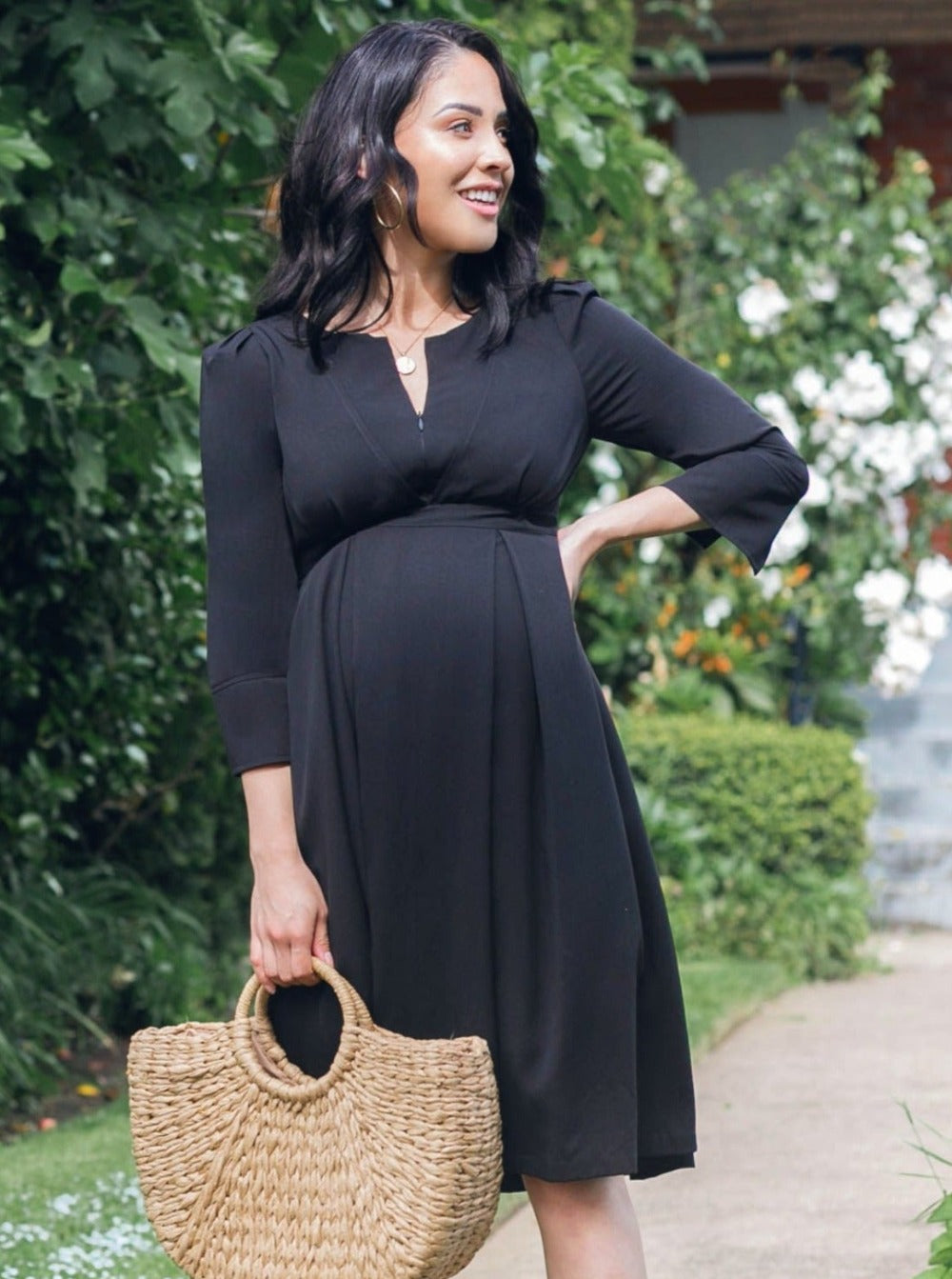 Black maternity and breastfeeding dress by MARION. Sustainable TENCEL empire waist style with deep pockets and full feminine skirt. Breastfeeding friendly with 3/4 sleeves and elegant cuff detail. Petite sizing also available.